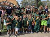 Members of the Souths Cares group with students and teachers from Cabbage Tree Island Public School. Picture by Mitchell Craig.