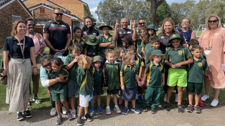 Members of the Souths Cares group with students and teachers from Cabbage Tree Island Public School. Picture by Mitchell Craig.